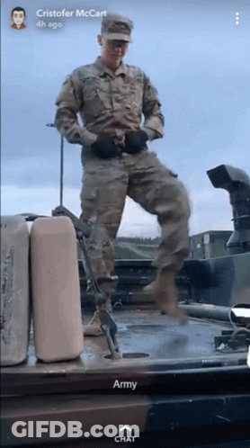 A Man In A Military Uniform Is Standing On Top Of A Military Vehicle With The Words Army Chat Below Him GIF