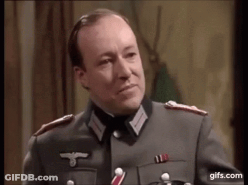 A Man In A Military Uniform Is Talking To Another Man . GIF