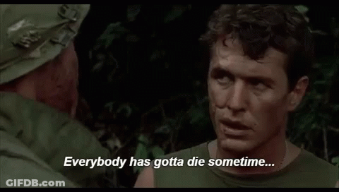 A Man In A Military Uniform Is Talking To Another Man In A Forest . GIF