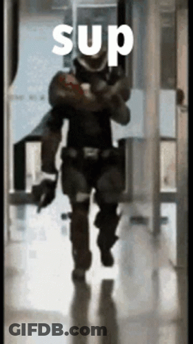 A Man In A Military Uniform Is Walking Down A Hallway With The Word Sup On It GIF
