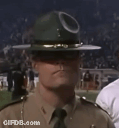 A Man In A Military Uniform Is Wearing A Hat With A Hole In It GIF