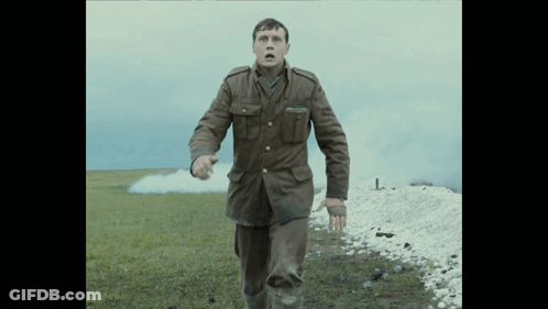A Man In A Military Uniform Runs In A Field GIF
