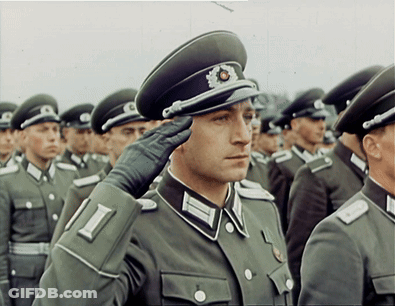 A Man In A Military Uniform Salutes In A Line GIF