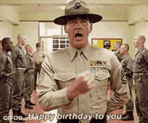 A Man In A Military Uniform Says Happy Birthday To You In Front Of A Group Of Soldiers GIF