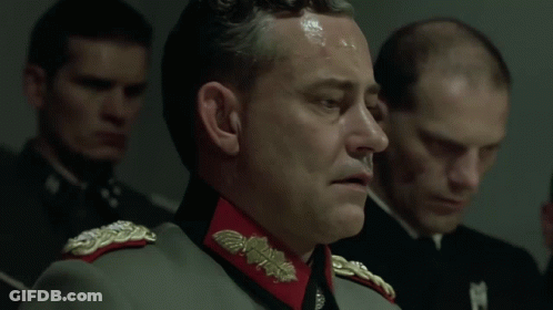 A Man In A Military Uniform Says " My Führer " In Front Of A Group Of Men GIF