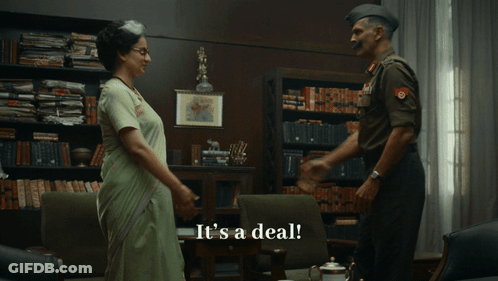 A Man In A Military Uniform Shakes Hands With A Woman In A Sari GIF
