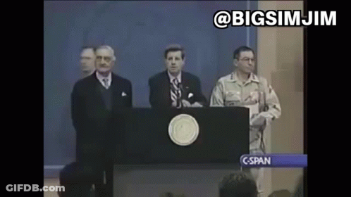 A Man In A Military Uniform Stands Behind A Podium Giving A Speech To A Crowd . GIF