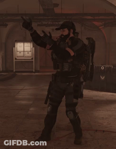 A Man In A Military Uniform Stands In A Dark Room Holding A Rifle GIF