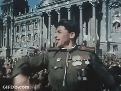 A Man In A Military Uniform Stands In Front Of A Crowd GIF