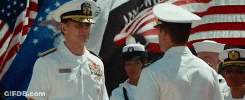 A Man In A Military Uniform Stands In Front Of A Flag That Says Liberty GIF