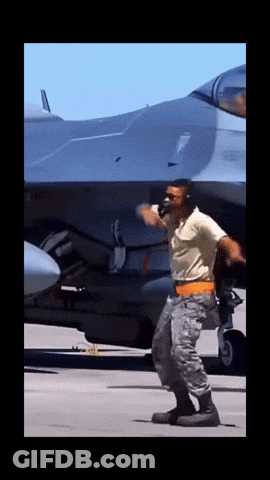 Man In Military Uniform In Front Of Jet GIF
