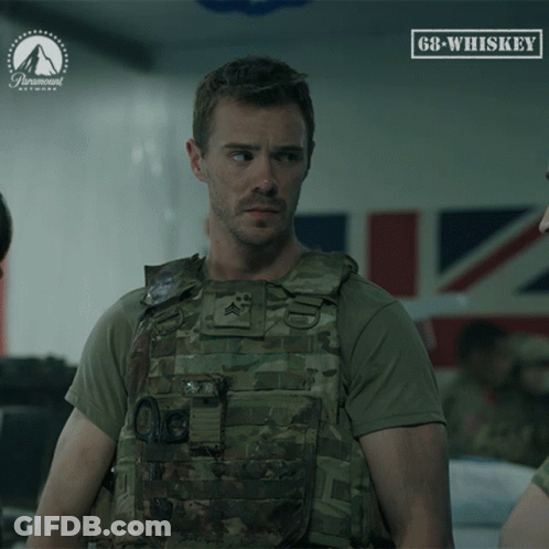 A Man In A Military Uniform Stands In Front Of A Sign That Says 68 Whiskey GIF