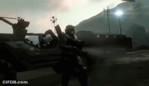 A Man In A Military Uniform Stands In Front Of A Vehicle That Says Y-520-V GIF