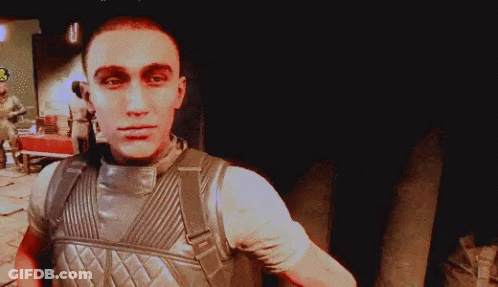 A Man In A Military Uniform With A Backpack Looks At The Camera GIF