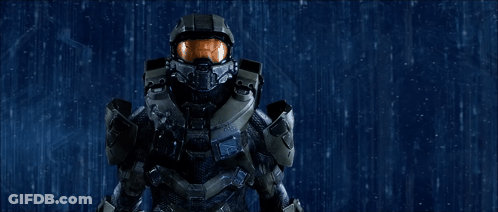 A Man In A Military Uniform With A Helmet On Stands In The Rain GIF