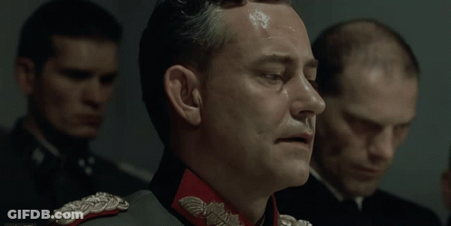 A Man In A Military Uniform With A Red Collar And A Silver Eagle On It GIF