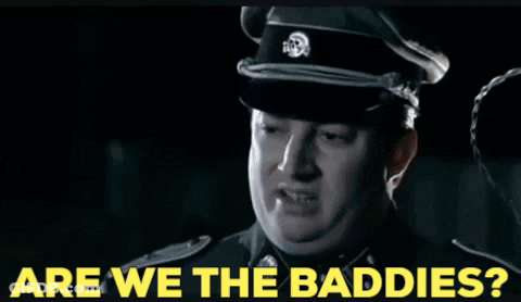 A Man In A Military Uniform With The Words Are We The Baddies On The Bottom GIF