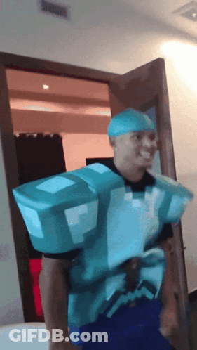 A Man In A Minecraft Costume Is Standing In A Room GIF
