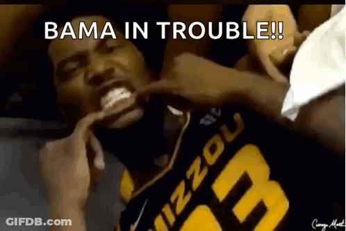 A Man In A Mizzou Jersey Is Laying On The Ground GIF