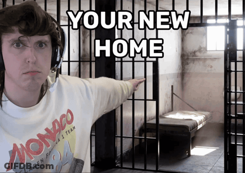 A Man In A Monaco Shirt Is Pointing To A Cell In A Jail Cell GIF