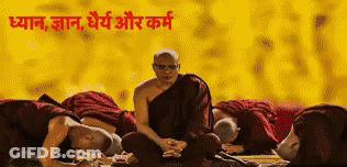 A Man In A Monk 'S Robe Sits In Front Of A Group Of People With Their Heads On The Ground GIF