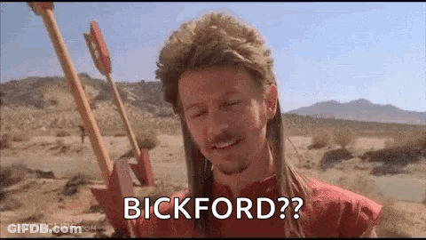 A Man In A Mullet Is Holding A Bow And Arrow In The Desert And Says Bickford ? GIF