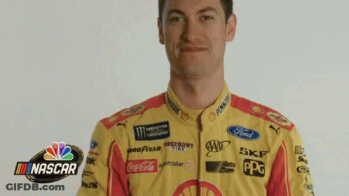 A Man In A Nascar Uniform Is Holding A Beach Ball In Front Of His Head GIF