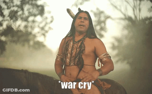 A Man In A Native American Outfit Is Riding A Horse With The Words " War Cry " Written Below Him GIF