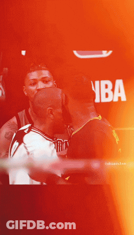 A Man In A Nba Jersey Kisses Another Man In A Dark Room GIF