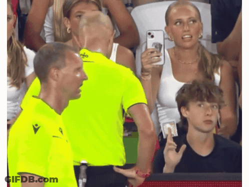 A Man In A Neon Yellow Shirt With The Word Macron On The Front GIF