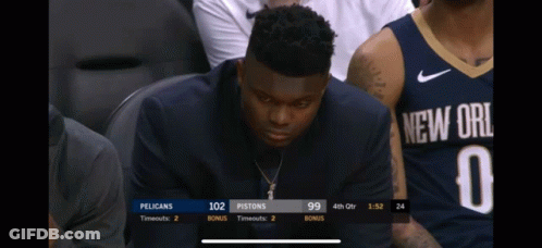 A Man In A New Orleans Jersey Sits In The Stands Watching A Game GIF