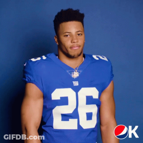 A Man In A New York Giants Jersey Poses For A Photo GIF