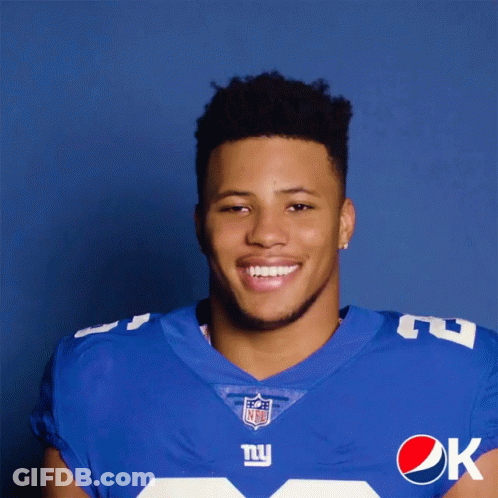 A Man In A New York Giants Uniform Is Holding A Pepsi Can GIF