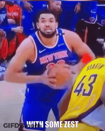 A Man In A New York Jersey Is Holding A Basketball In His Hands GIF