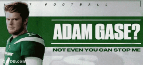 Man In Jets Jersey In Front Of Adam Gase Sign GIF