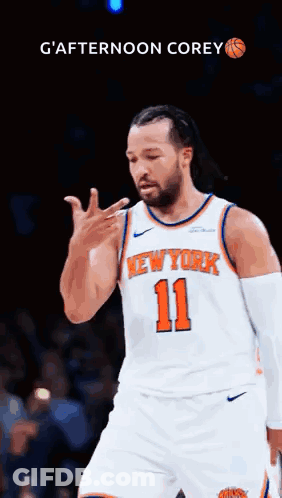 A Man In A New York Knicks Jersey Is Giving A Thumbs Up . GIF