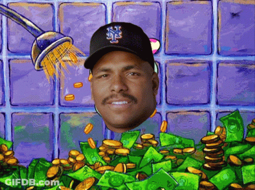 A Man In A New York Mets Hat Is Surrounded By Coins And Bills GIF