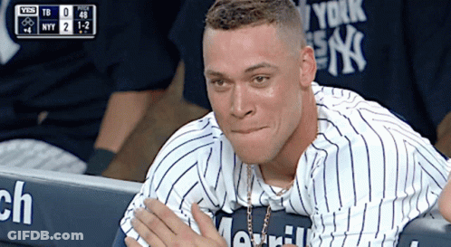 A Man In A New York Yankees Jersey Sits In The Dugout During A Game GIF