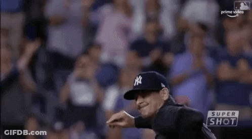A Man In A New York Yankees Uniform Is Throwing A Baseball . GIF