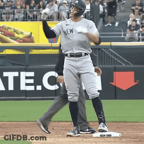 A Man In A New York Yankees Uniform Stands On A Base GIF