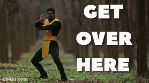 A Man In A Ninja Costume Is Standing In The Woods With The Words " Get Over Here " Behind Him GIF