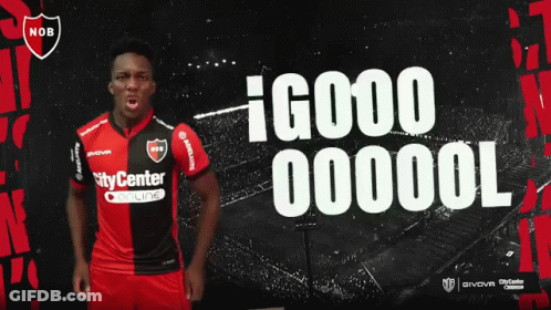 A Man In A Nob Jersey Stands In Front Of A Soccer Field GIF