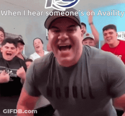 A Man In A Nobull Shirt Is Screaming In Front Of A Crowd Of People GIF