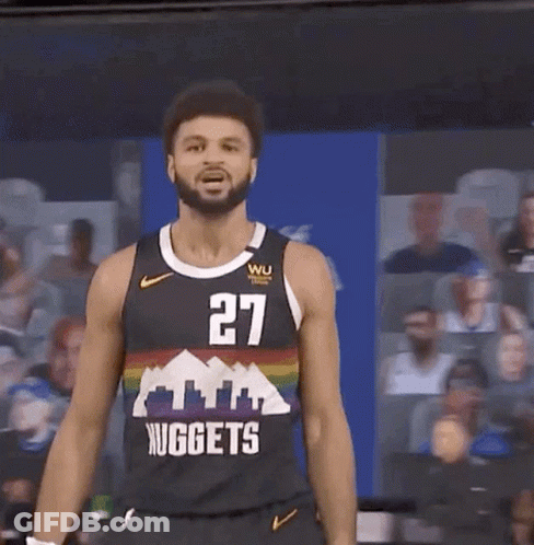 A Man In A Nuggets Jersey Stands In Front Of A Crowd GIF
