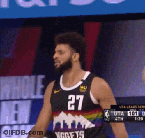 A Man In A Nuggets Jersey Stands In Front Of A Screen GIF