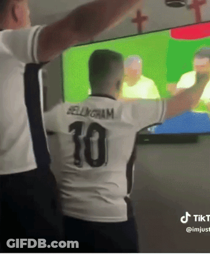 A Man In A Number 10 Jersey Stands In Front Of A Tv GIF