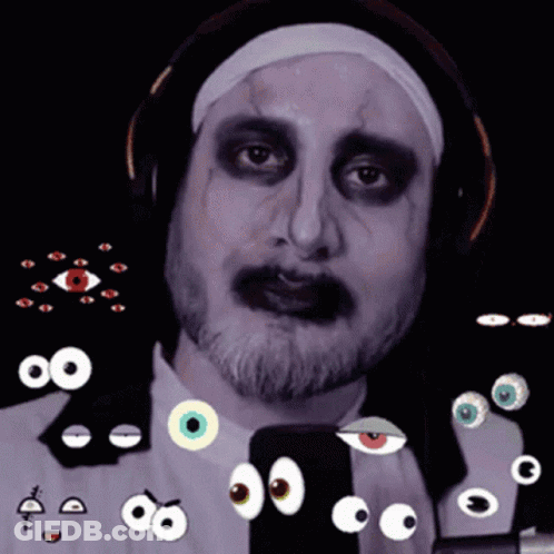 A Man In A Nun Costume Has A Bunch Of Googly Eyes Around His Face GIF