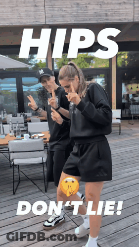 A Man In A Ny Hat Stands Next To A Woman In A Black Outfit GIF