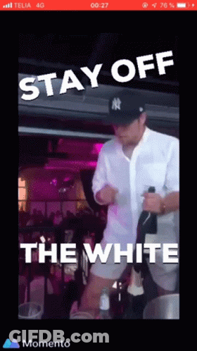 A Man In A Ny Yankees Hat Is Holding A Bottle Of Champagne GIF