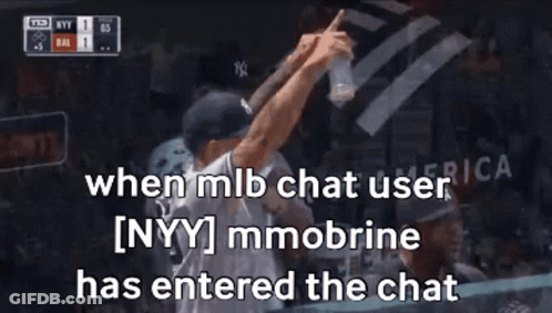 A Man In A Ny Yankees Hat Is Holding A Bottle Of Water In His Hand . GIF